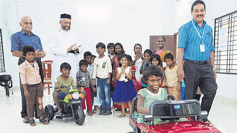 Kids with headmaster Biju Thomas Amboori during the inauguration of the electric toy car at Government Tribal LP School, Attathodu