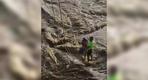 The man being rescued by the firefighters.