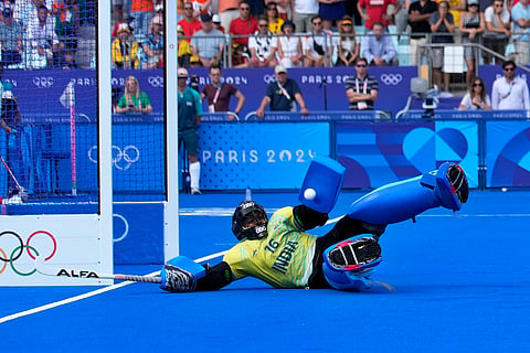 India's goalkeeper PR Sreejesh saves a shot by Britain's Phil Roper in the shoot-out during the men's quarterfinal at the Yves-du-Manoir Stadium