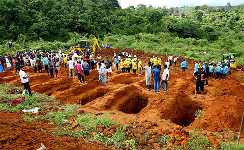 Volunteers prepare graveyard for cremating the unidentified bodies recovered from the landslide-hit areas in Wayanad's Chooralmala and Mundakai at Harrisons Tea Estate, Puthumala.