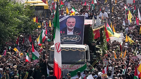 Iranians follow a truck, center, carrying the coffins of Hamas leader Ismail Haniyeh and his bodyguard who were killed in an assassination blamed on Israel on Wednesday, during their funeral ceremony at Enqelab-e-Eslami (Islamic Revolution) Sq. in Tehran, Iran, Thursday, Aug. 1, 2024.