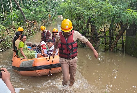 A family being evacuated from a water logged area near Mangaluru on Thursday.
