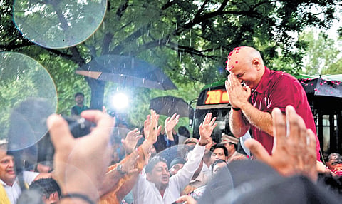 Former deputy chief minister Manish Sisodia greeting AAP workers outside Tihar Jail after his release on bail on Friday.