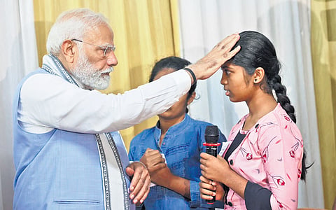 Modi interacts with inmates at a relief camp in Meppadi
