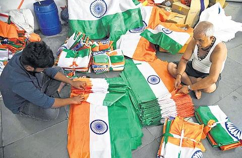 Ahead of Independence Day, employees pack national flags at a work shop in Hyderabad on Monday