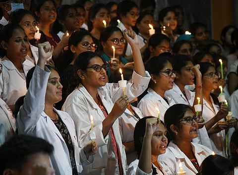 Junior doctors protest the rape and murder of a young medic from Kolkata, during a candle light demonstration at the Gandhi Hospital in Hyderabad