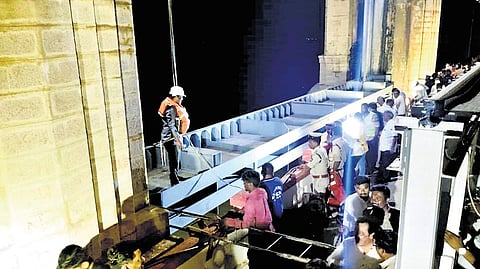 One of the stoplogs being lowered at crest gate 19 of the TB dam on Friday