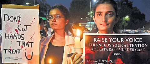 Medical students protest against the rape and murder of a PG student in a Kolkata hospital, in Bengaluru on Friday
