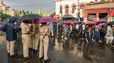 Police personnel keep vigil as members of the Indian Medical Association (IMA) take part in a protest march amid its 24-hour nationwide strike demanding justice for the woman doctor who was allegedly raped and murdered at R G Kar Medical College and Hospital, in Kolkata.
