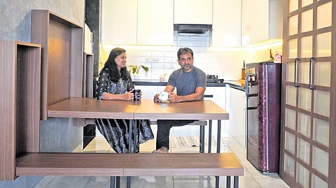 Vinay Ananth and Shaila Kulkarni’s home Swasti, while compact, features space-saving furniture like this six-seater wall-mounted dining table that also doubles as a minimalist wall art