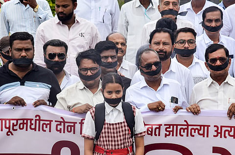 Maha Vikas Aghadi (MVA) leaders and workers protest with black ribbons tied to their mouths against the Badlapur sexual assault case at Karad, in Satara district, Saturday, Aug. 24, 2024.