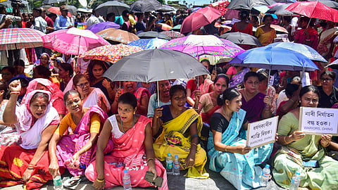 Locals block a road during a protest against an alleged gang-rape of a 14-year-old girl by three men at the Dhing area, in Nagaon district.