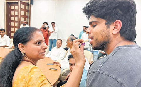 BRS MLC K Kavitha celebrates with her son after her release from jail on bail in the Delhi liquor policy scam cases, at the BRS party office in New Delhi on Tuesday.