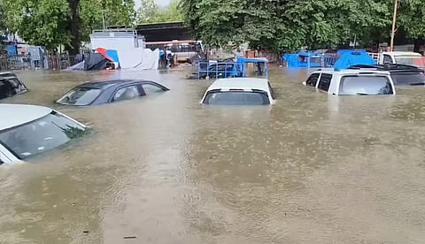 Cars submerged in water due to floods in Gujarat.