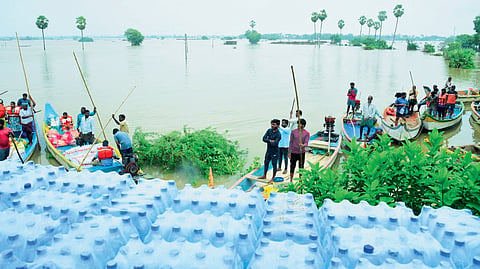 Food and water being supplied to villagers stranded in floods in Bapatla