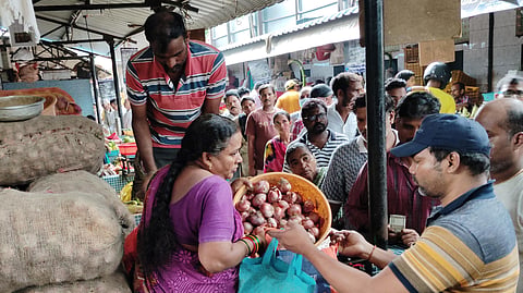 People waiting in a queue line to buy onions at Rythu Bazar in Visakhapatnam on Wednesday