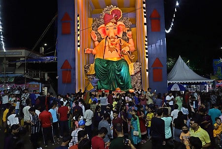 People gather at Bargarh puja mandap to witness 57feet tall Load Ganesh idol in Bhubaneswar on Saturday