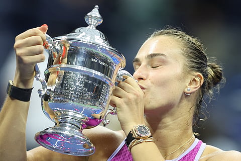 Belarus's Aryna Sabalenka kisses the trophy after defeating USA's Jessica Pegula during their women's final match on day thirteen of the US Open tennis tournament at the USTA Billie Jean King National Tennis Center in New York City, on September 7, 2024.