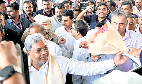 Chief Minister Siddaramaiah receives a bouquet of flowers from a supporter during his Bengaluru City rounds on Thursday.