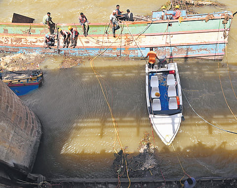 Experts from Visakhapatnam were roped in to cut the iron boats, which have been stuck in the gates of the Prakasam Barrage, under the water