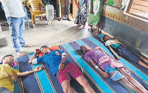 Affected villagers lying after being administered medicines by the health team