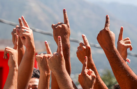 Voters show their fingers marked with indelible ink after casting votes during the first phase of Jammu and Kashmir Assembly elections, in Kishtwar, Wednesday, Sept. 18, 2024.