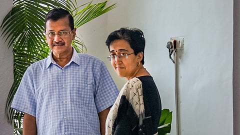 Former Delhi Chief Minister Arvind Kejriwal with CM-designate Atishi