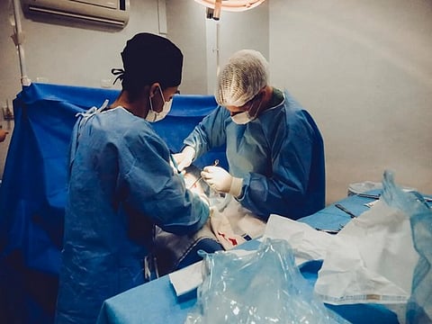 When a long-standing bullet starts causing life-threatening bleeding, immediate surgery becomes necessary.