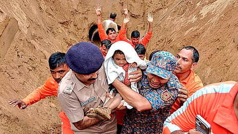 A 2-year-old child, trapped in a 35 feet deep pit, being rescued by NDRF and SDRF personnel, in Dausa, Rajasthan.