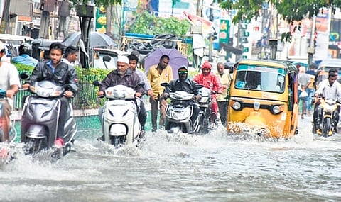 Two-wheelers wading through water logged roads in Tirupati