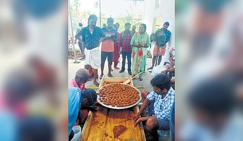 Workers at the Alangad jaggery-making unit rolling up balls of jaggery
