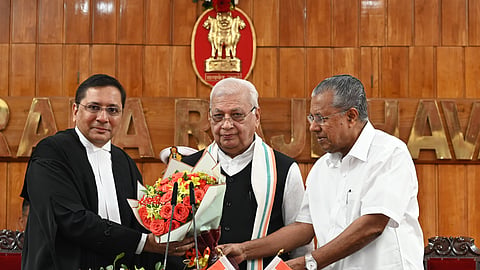 Justice Nitin Madhukar Jamdar, who was sworn is as Chief Justice of Kerala High Court, with Governor Arif Mohammed Khan (centre) and Chief Minister Pinarayi Vijayan.