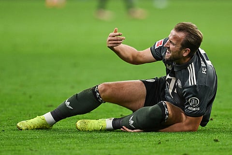 Munich's Harry Kane lies on the pitch in pain during the German Bundesliga soccer match between Bayern Munich and Leverkusen at the Allianz Arena in Munich, Germany, Saturday, Sept. 28, 2024.