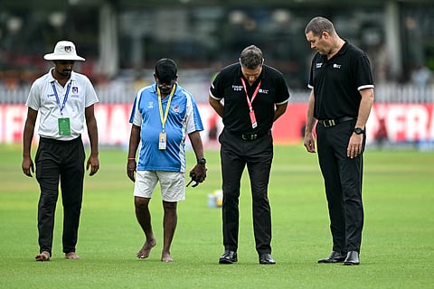 Match officials inspect the field before the start of the third day play of the second Test cricket match between India and Bangladesh at the Green Park Cricket Stadium in Kanpur on September 29, 2024.
