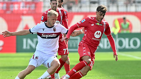 AC Monza's Daniel Maldini, right, and Bologna's Jens Odgaard, left, challenge for the ball during a Serie A soccer match between Monza and Bologna in Monza, Italy