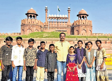 Class 8 students of Zilla Parishad High School (ZPHS) in Mallapur, Thimmapur mandal, Karimnagar district, along with their Hindi teacher during an educational tour in New Delhi.