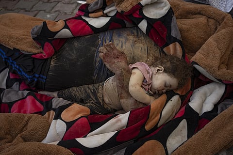 The bodies of a father and his child killed in the Israeli bombardment of the Gaza Strip, lie in front of the morgue at Al Aqsa hospital in Deir Al-Balah, Sunday, Oct 22, 2024