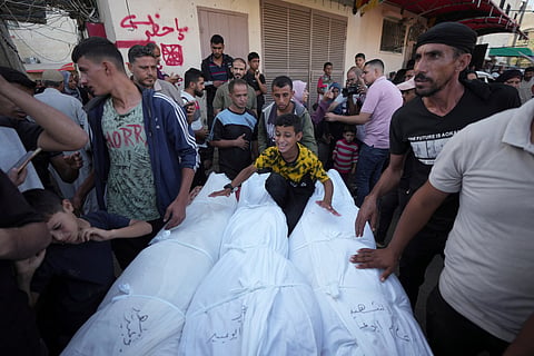 Mourners gather around bodies of Palestinians killed in the Israeli bombardment of the Gaza Strip, outside the hospital morgue in Deir al-Balah on Wednesday, Oct. 9, 2024.