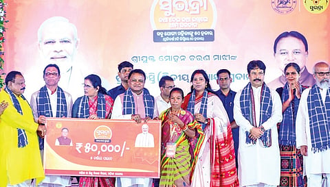 Chief Minister Mohan Charan Majhi and deputy CM Pravati Parida handing out assistance to a Subhadra Yojana beneficiary at Baripada on Wednesday