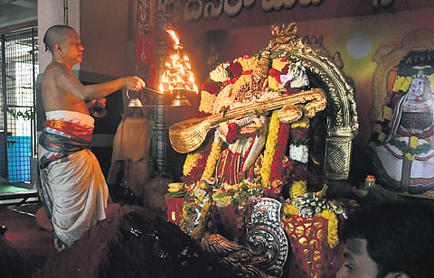 A priest seen offering harathi to Goddess Durga;
