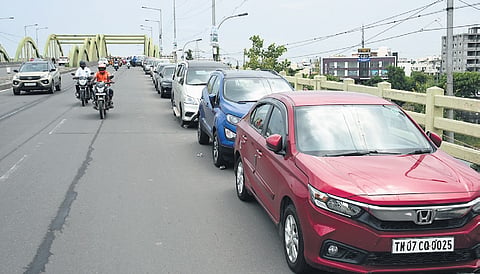 Cars parked on the Velachery bridge in Chennai in anticipation of widespread flooding from rains Bikes moving along a flooded street in Madurai