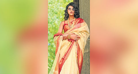 Sari in cream and gold with heavy gold border and zari motifs all over
