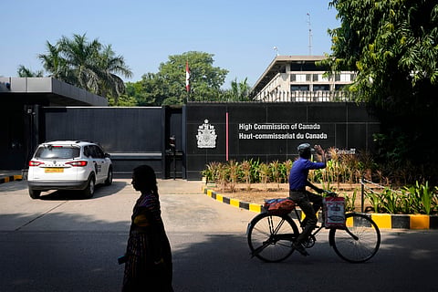 A cyclist pedals past the Canadian high commission in New Delhi, India, Tuesday, Oct. 15, 2024 after India and Canada expelled each other’s top diplomats over an ongoing dispute about the killing of a Sikh activist in Canada.
