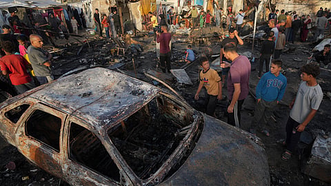 Palestinians look at the damage after an Israeli strike hit a tent area in the courtyard of Al Aqsa Martyrs hospital in Deir al Balah, Gaza Strip on Monday.