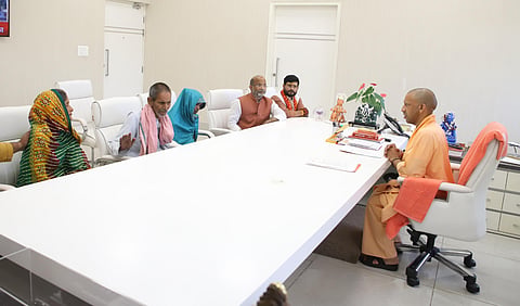 UP CM Yogi Adityanath with the family of the deceased
