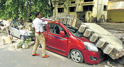 The boundary wall of Kamala Nehru Women’s Hostel collapsed, damaging five cars parked near it, in Vijayawada on Wednesday