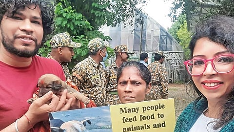 Volunteers take part in the Kukur Tihar at the BBMP head office on Thursday
