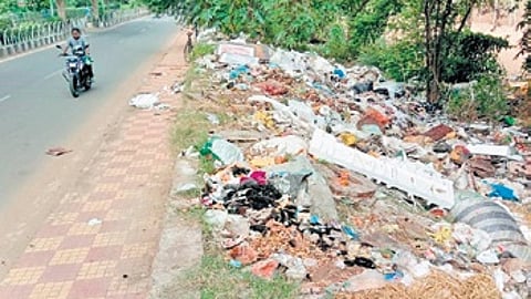 Puja waste dumped alongside the road on Mahanadi riverbank near Matamatha