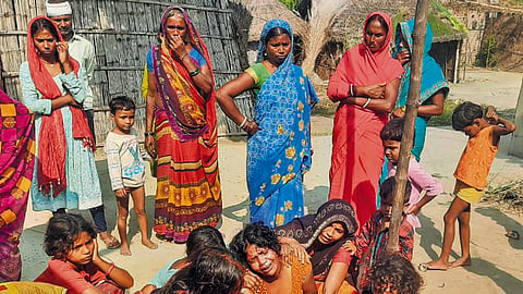 Family members mourn the death of hooch tragedy victims, in Saran district, Thursday, Oct. 17, 2024.