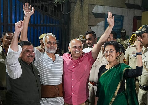AAP leader and former Delhi health minister Satyendar Jain greets supporters with Delhi Chief Minister Atishi and party leaders Manish Sisodia and Sanjay Singh after the former walked out of the Tihar Jail, in New Delhi, Friday, Oct. 18, 2024.